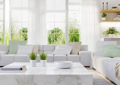 living room facing windows. White couches gray and white marble coffee table