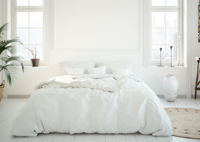 bed with white down comforter